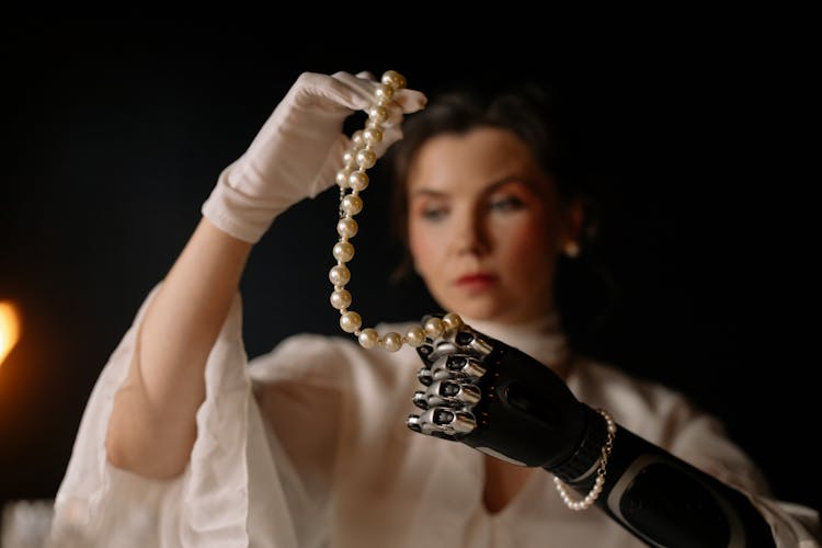 Woman Holding A String Of Pearls