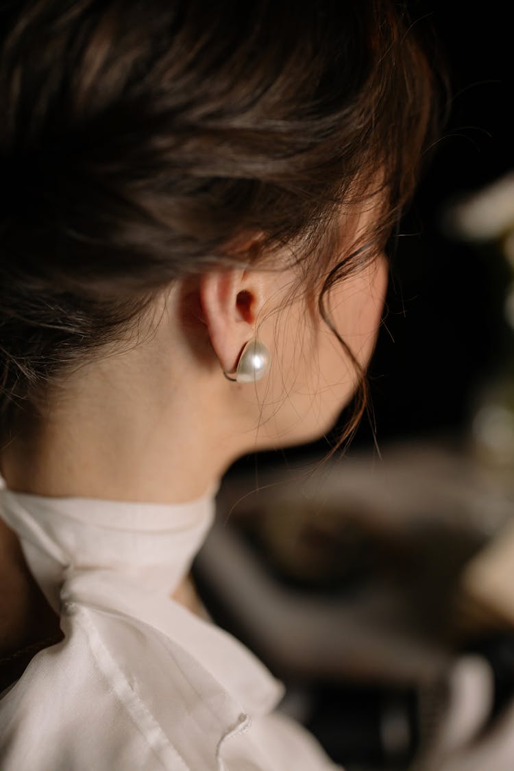 Woman In White Wearing A Pearl Earring