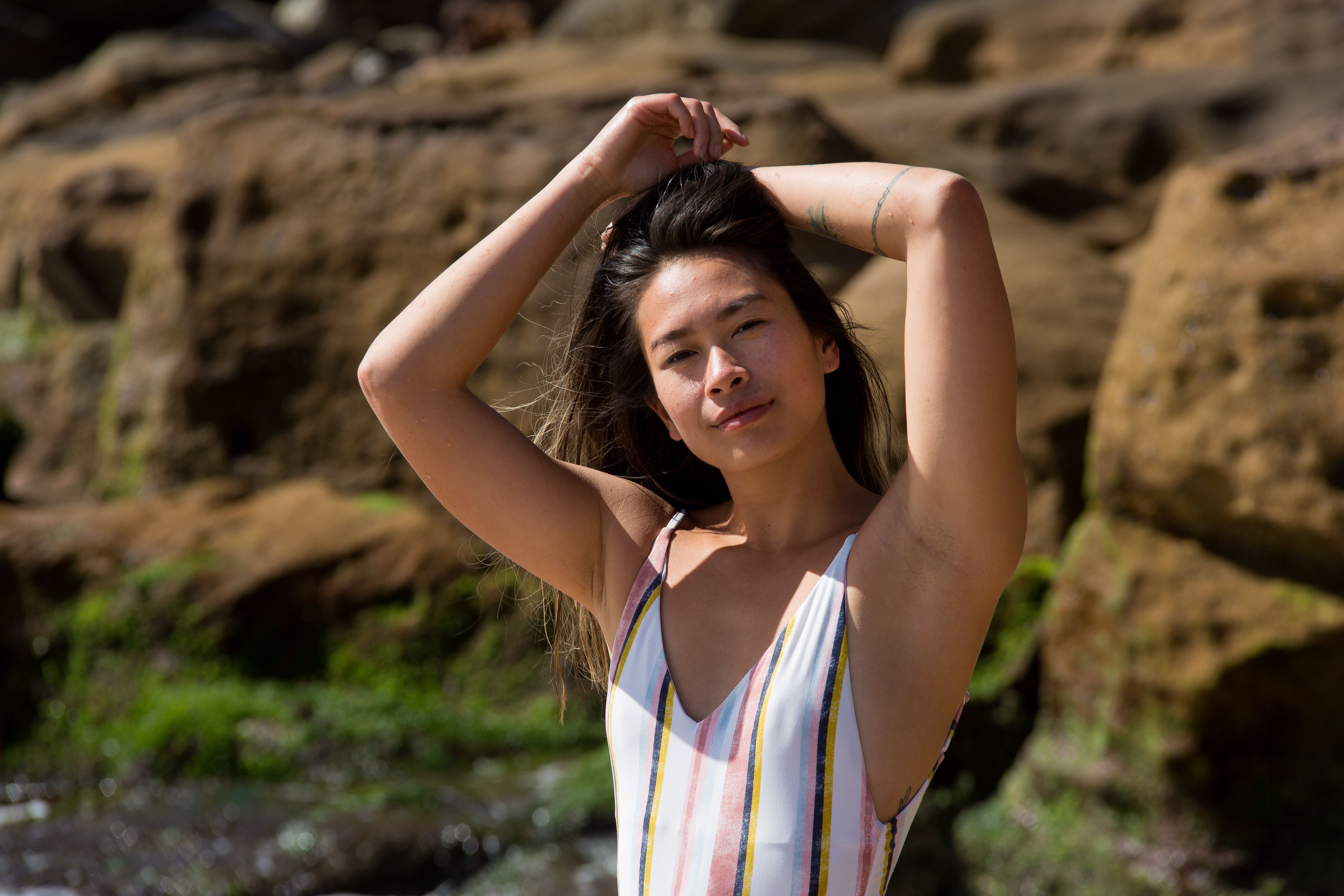 Woman With Long Hair Wearing a Striped Bathing Suit · Free Stock Photo
