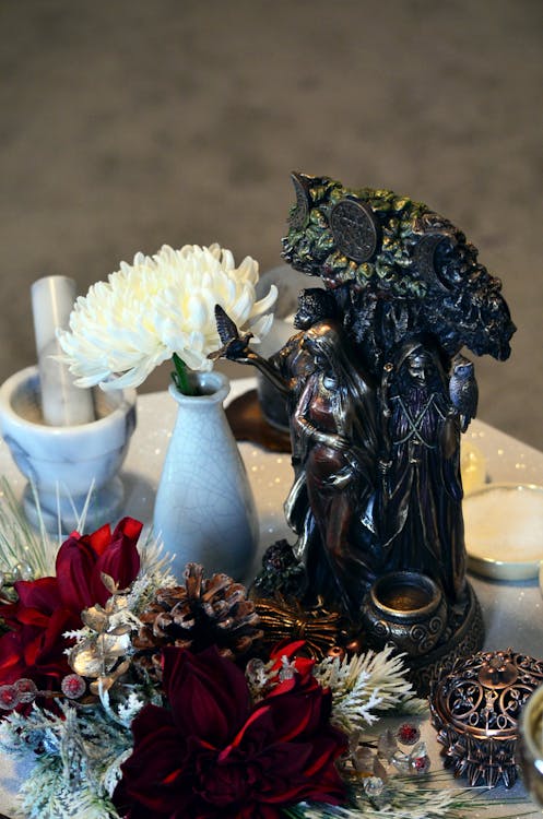 Black Ceramic Figurine on Brown Wooden Table