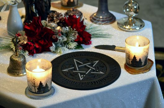 Ornaments and Lighted Candle on a Table 