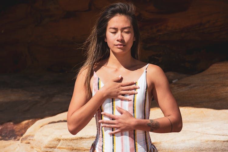 Woman In Swimsuit Holding Chest