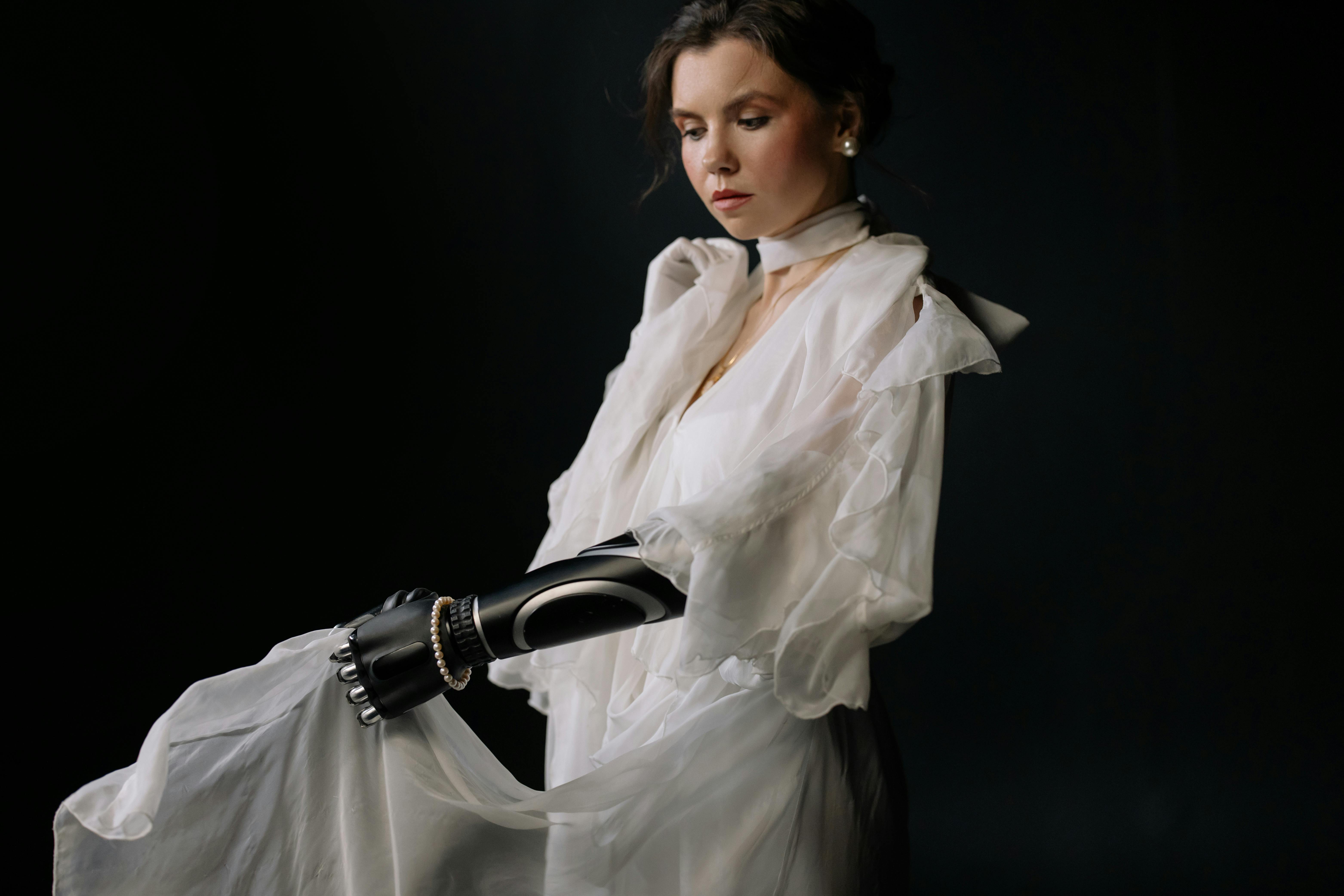 woman in white dress shirt and black leather gloves