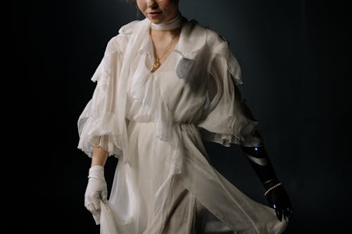 Woman in White Dress with Prosthetic Arm