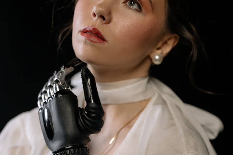 Woman With Prosthetic Hand Holding Her Neck