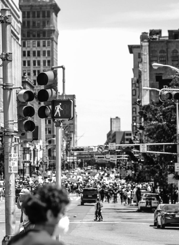 Unrecognizable People On Urban Road Between Old Multistory Buildings