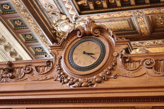 Beautiful wooden clock with intricate carvings in a New York library.