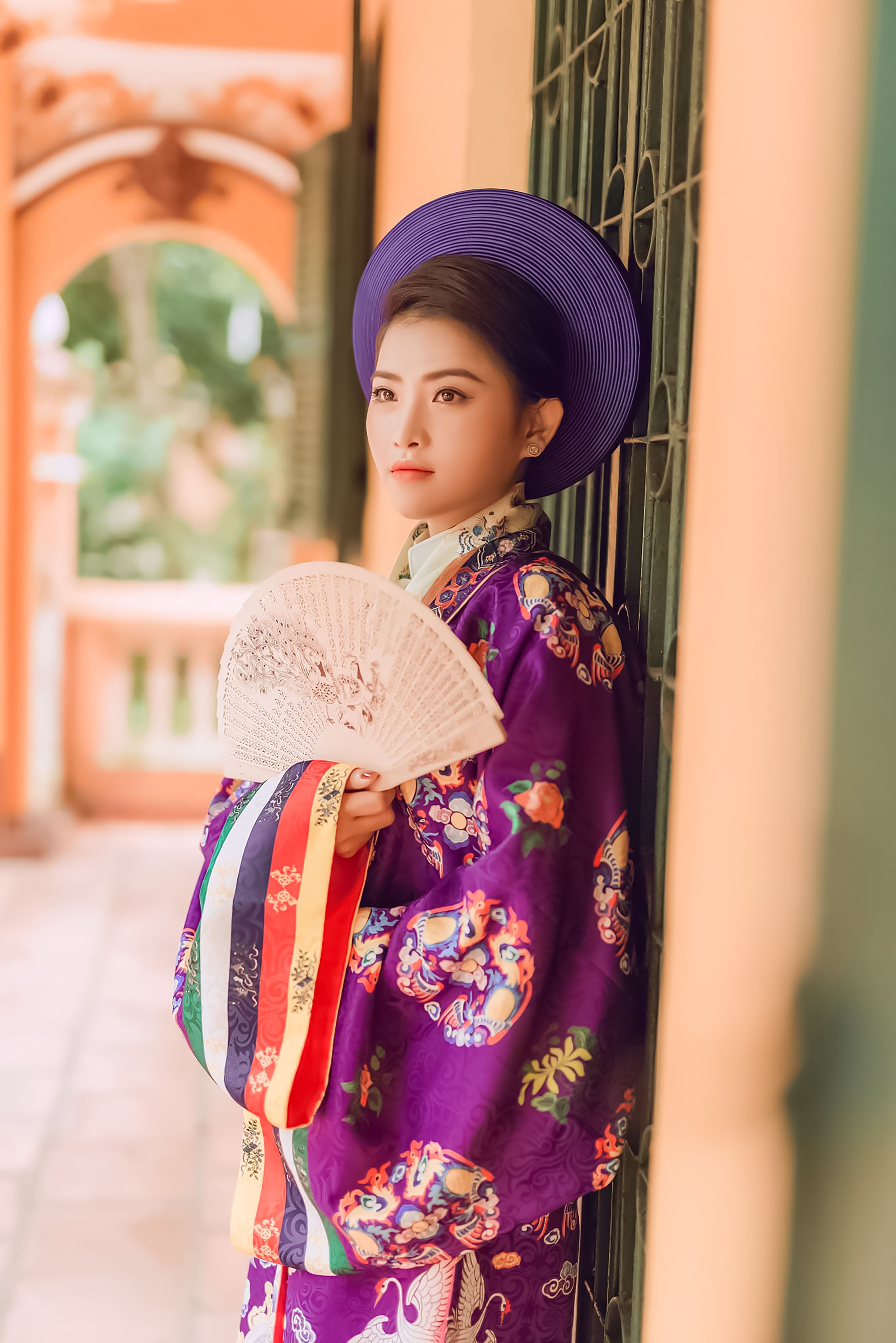 A Woman in Traditional Clothing Standing by the Doorway · Free Stock Photo