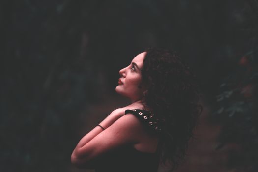 Artistic portrait of a woman looking upwards, showcasing serenity and solemnity.