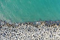 Aerial View of Wave Breakers on the Beach