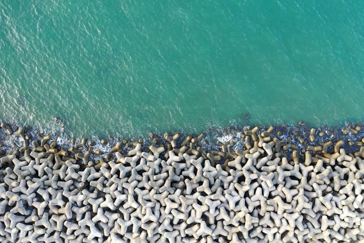 Aerial View Of Wave Breakers On The Beach