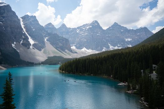 A stunning view of Moraine Lake with rugged mountains and evergreen forests in Banff National Park.