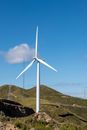 White Wind Turbine on Brown Field Under Blue Sky