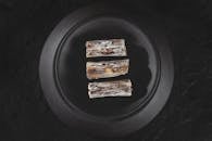 2 Brown and White Food on Black Plate