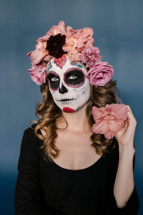 Woman in Black Scoop Neck Long Sleeve Shirt With Face Paint and Floral Headdress
