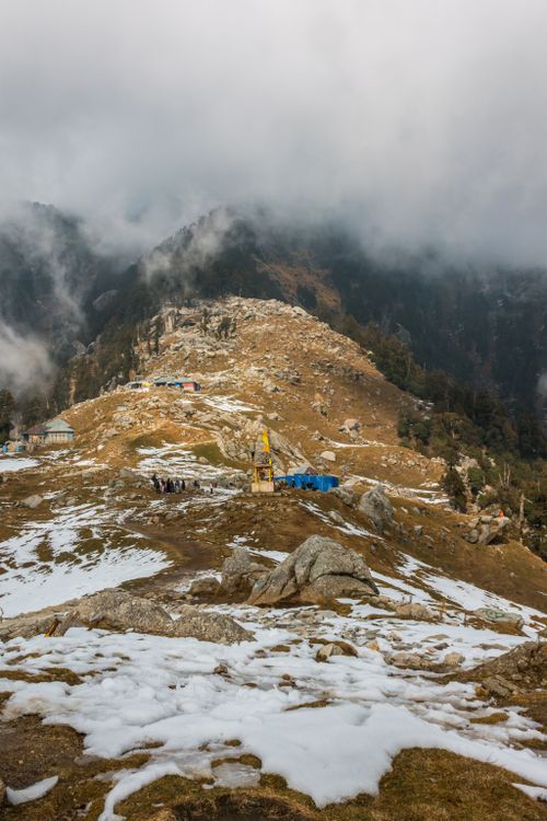 Free Breathtaking view of a snow-covered mountain landscape with misty fog and rocky terrain. Stock Photo