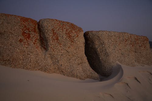 Stones in sandy terrain in evening