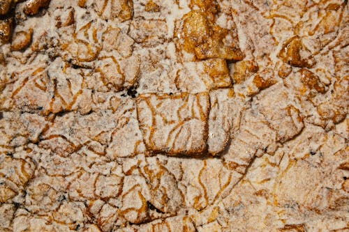 Top view of abstract weathered surface of rough rocky formation with uneven texture and relief