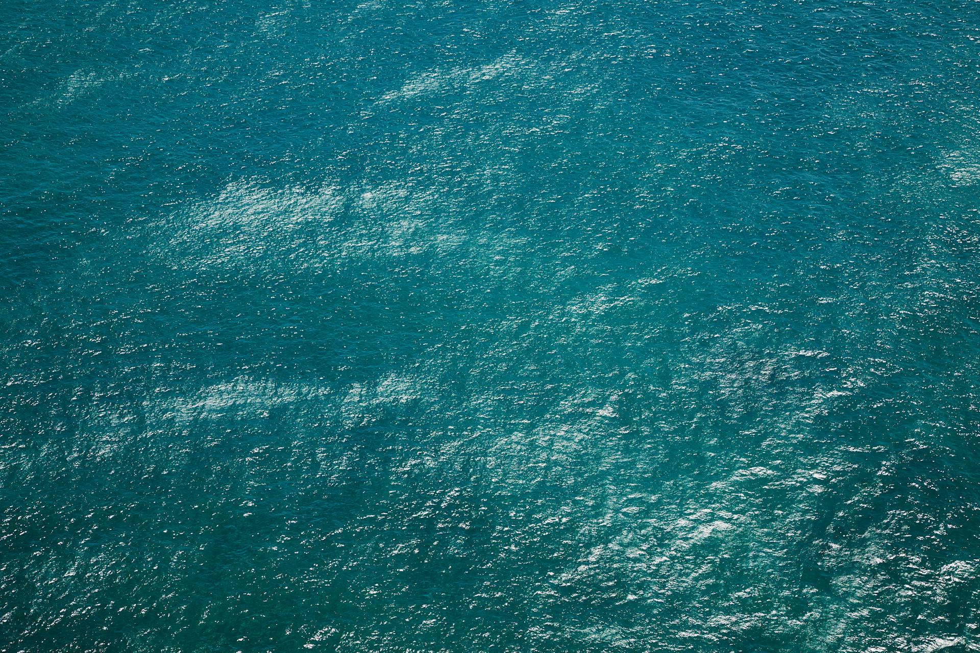 Drone view of rippling azure pure water of sea with little waves running on surface