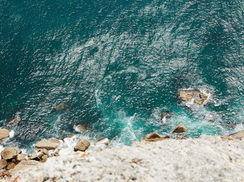 Free Rippling surface of sea near rocky cliff Stock Photo