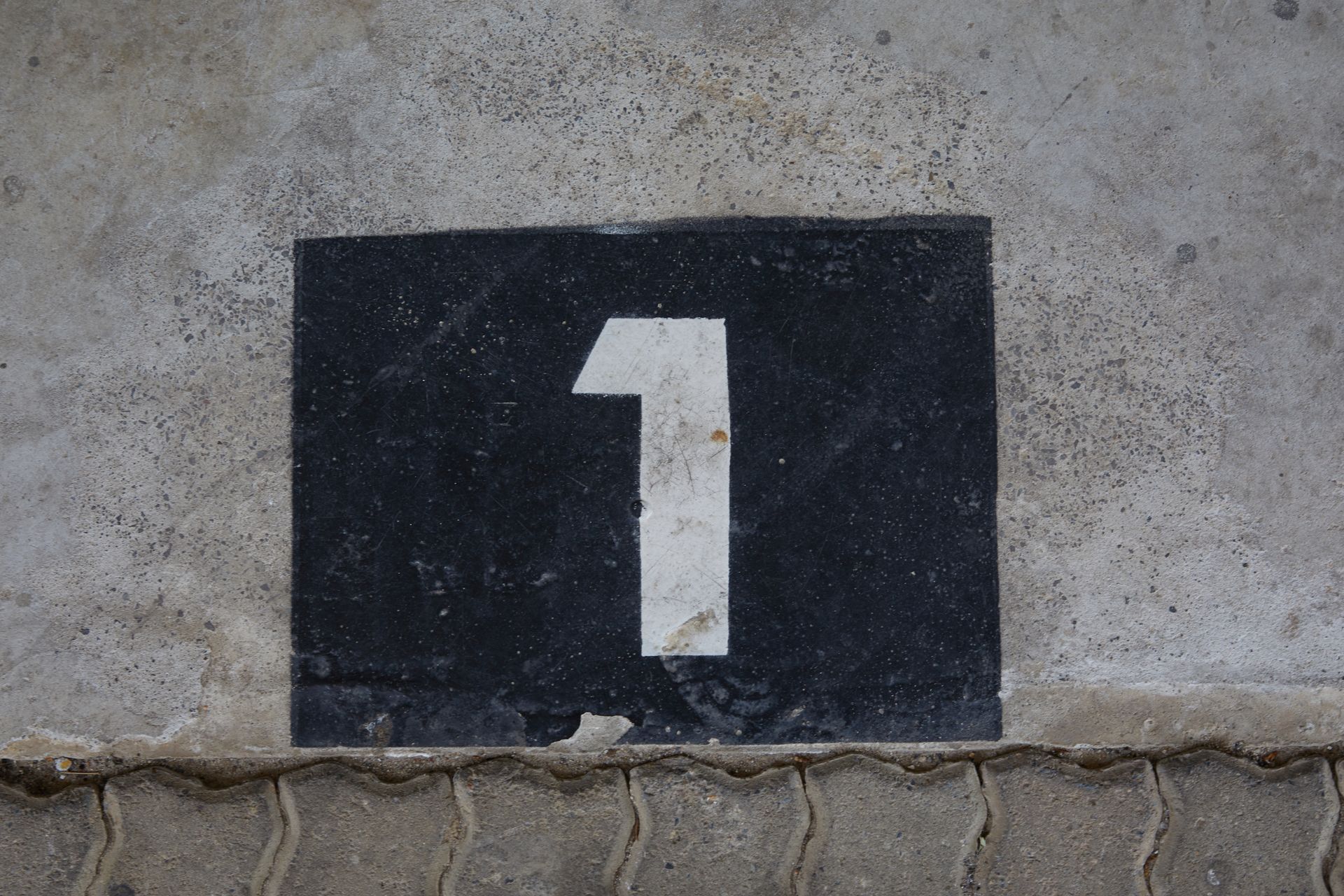Sign with house number on wall