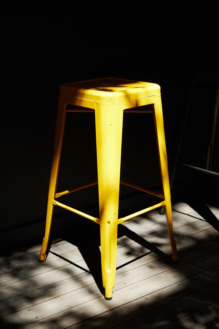 Yellow Bar Stool In Dark Room