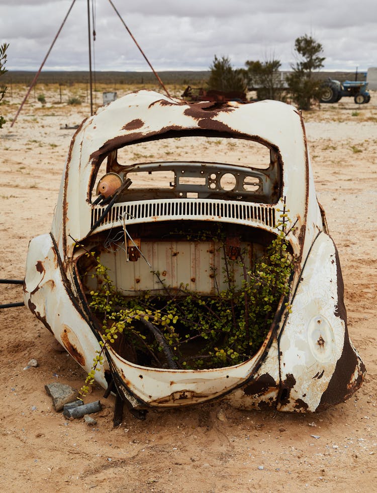 Abandoned Broken Car In Sandy Terrain