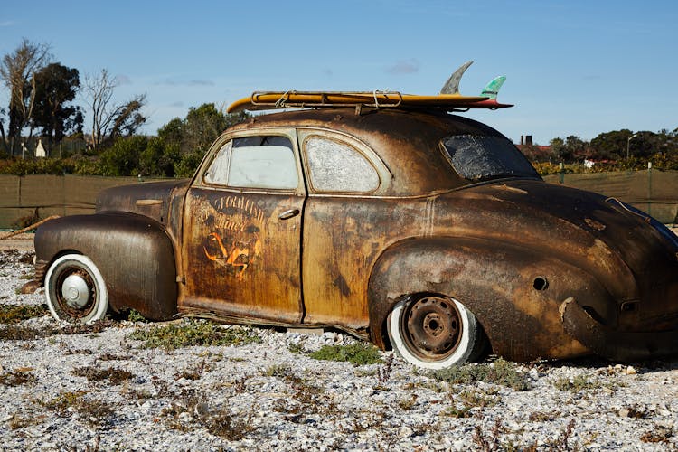 Vintage Rusty Broken Car On Gravel