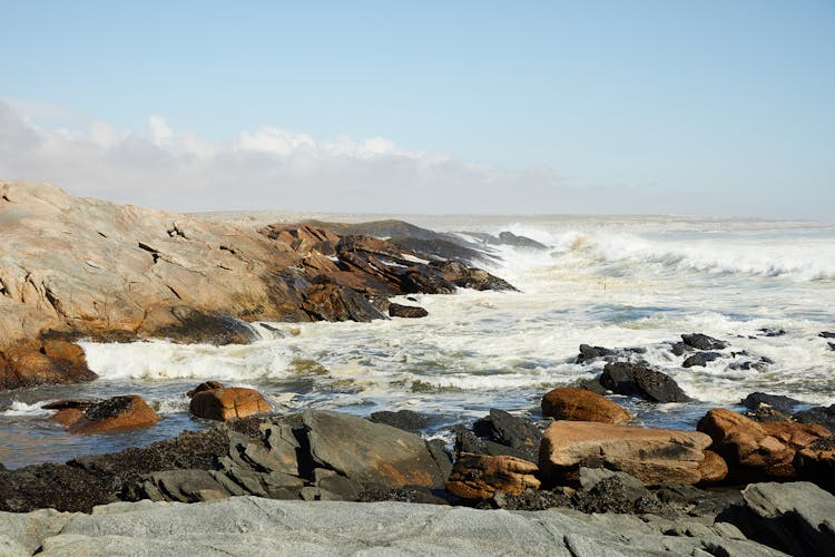 Waves Of Powerful Ocean Washing Rough Stones