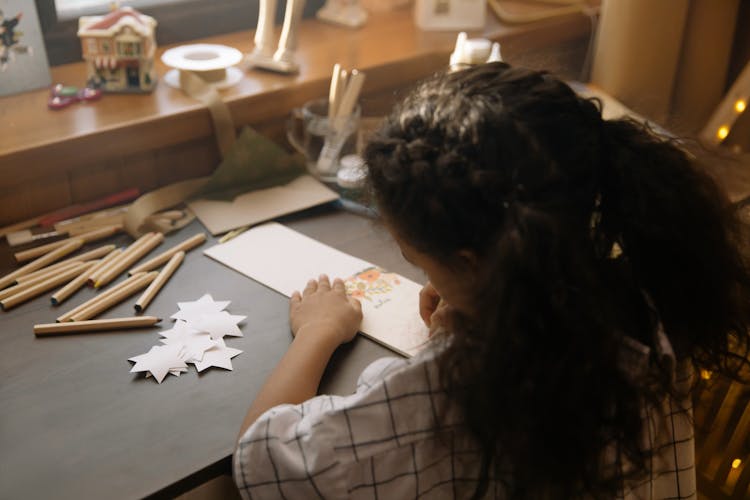 A Girl Writing A Christmas Letter