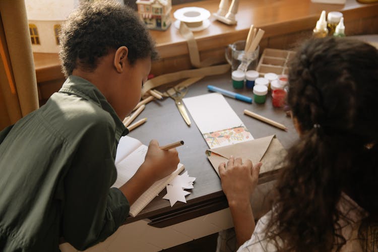 Two Kids Making And Writing A Christmas Letter