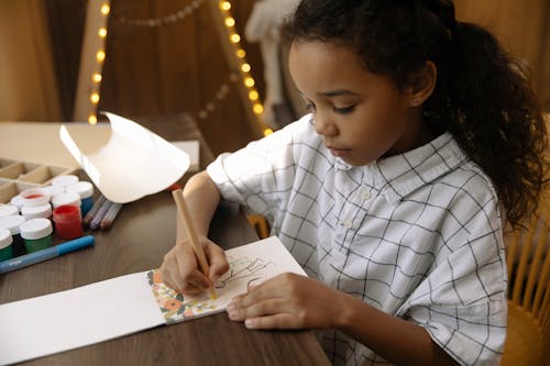 Free A Girl Making a Christmas Letter Stock Photo