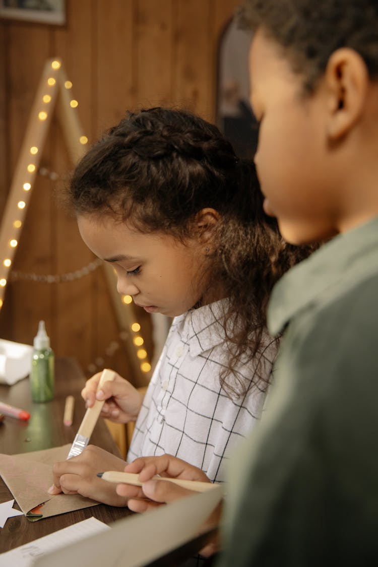 Two Kids Making A Christmas Letter