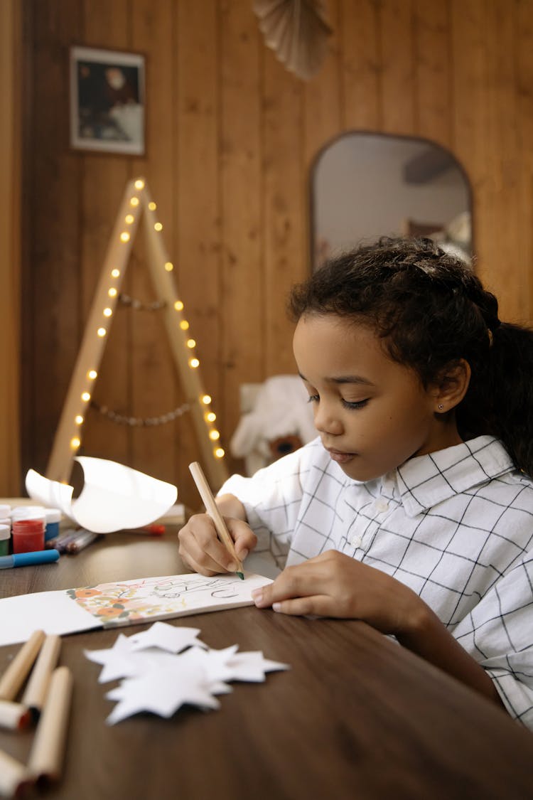 A Girl Making A Christmas Letter