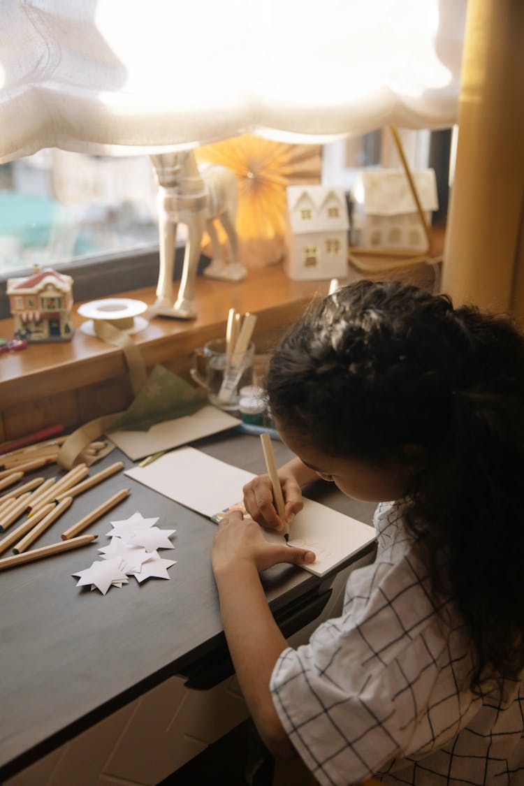 A Girl Making A Christmas Letter