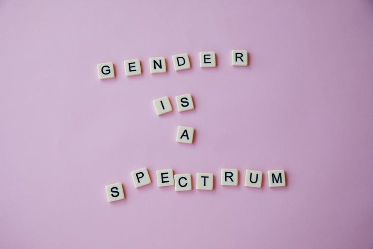 Inscription Gender Is A Spectrum Made Of Scrabble Letters Against Pink Background