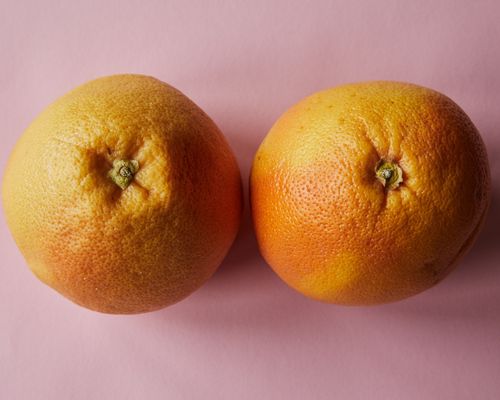 Free From above of fresh ripe tangerines placed on pink surface in light studio Stock Photo