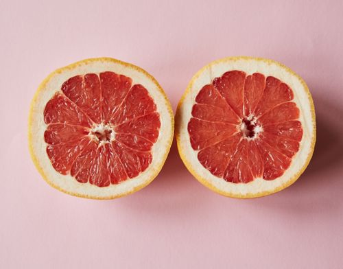 Free Top view of fresh sliced juicy grapefruit placed on pink background in studio Stock Photo