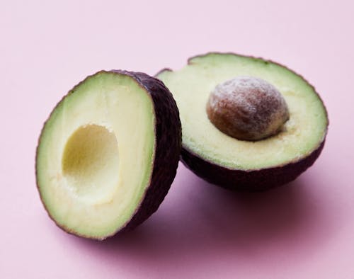 Free Halves of unpeeled avocado in studio Stock Photo