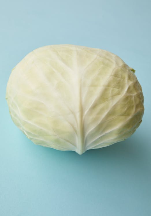 Free Whole ripe fresh cabbage arranged on blue surface Stock Photo