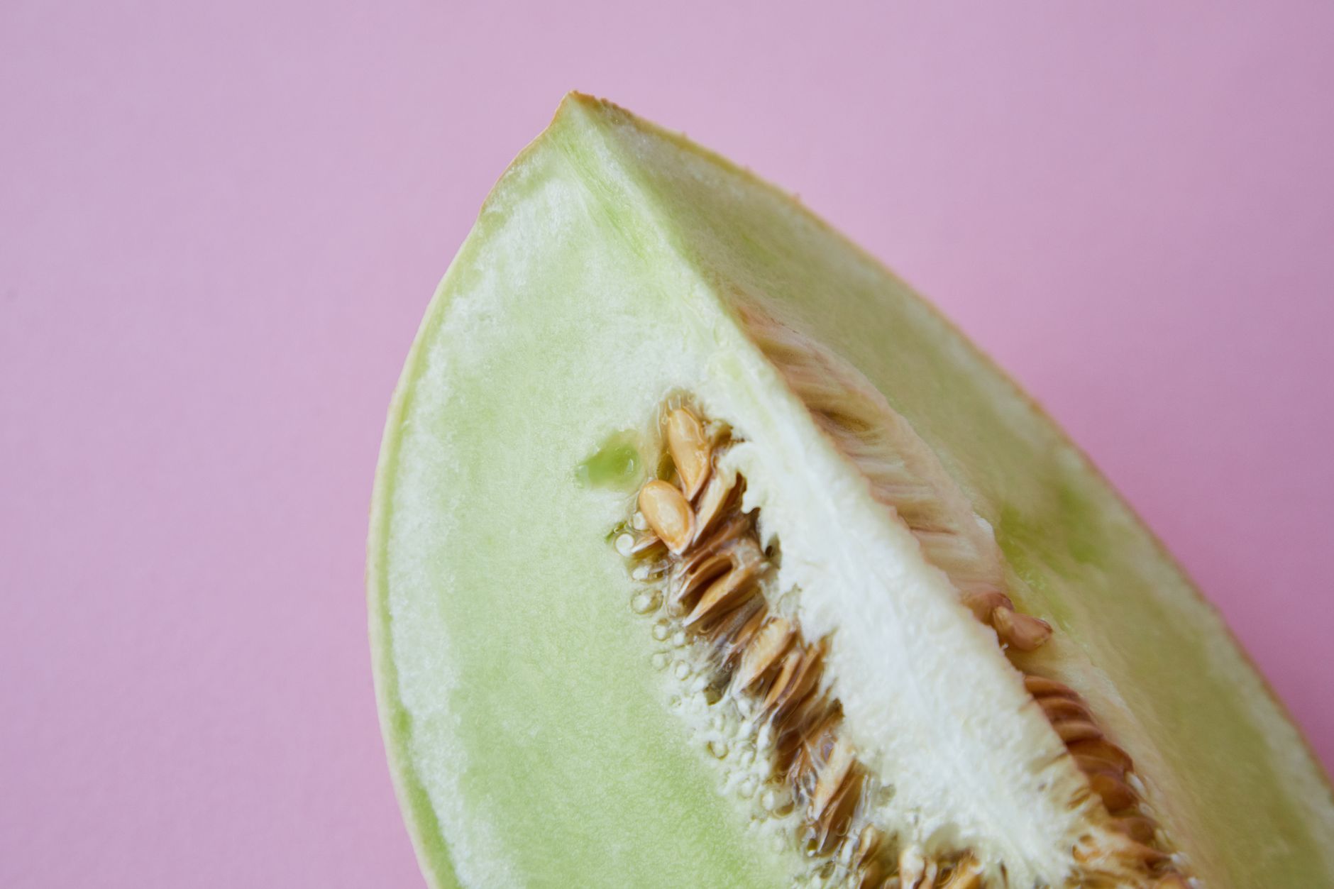 Fresh and spoiled cantaloupe comparison on a cutting board