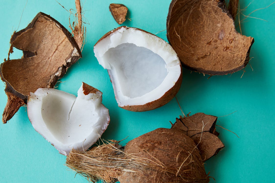 Free Pieces of cracked coconut with aromatic white pulp Stock Photo
