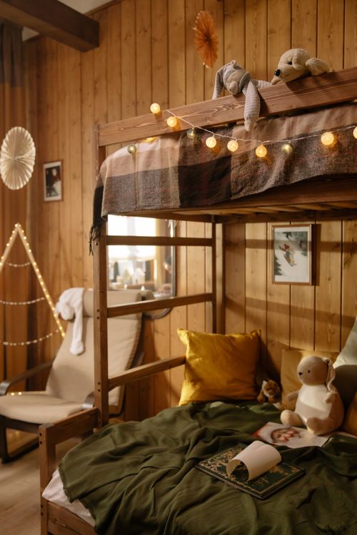 Free Warm and inviting rustic bedroom decorated with festive string lights, ideal for a Christmas setting. Stock Photo