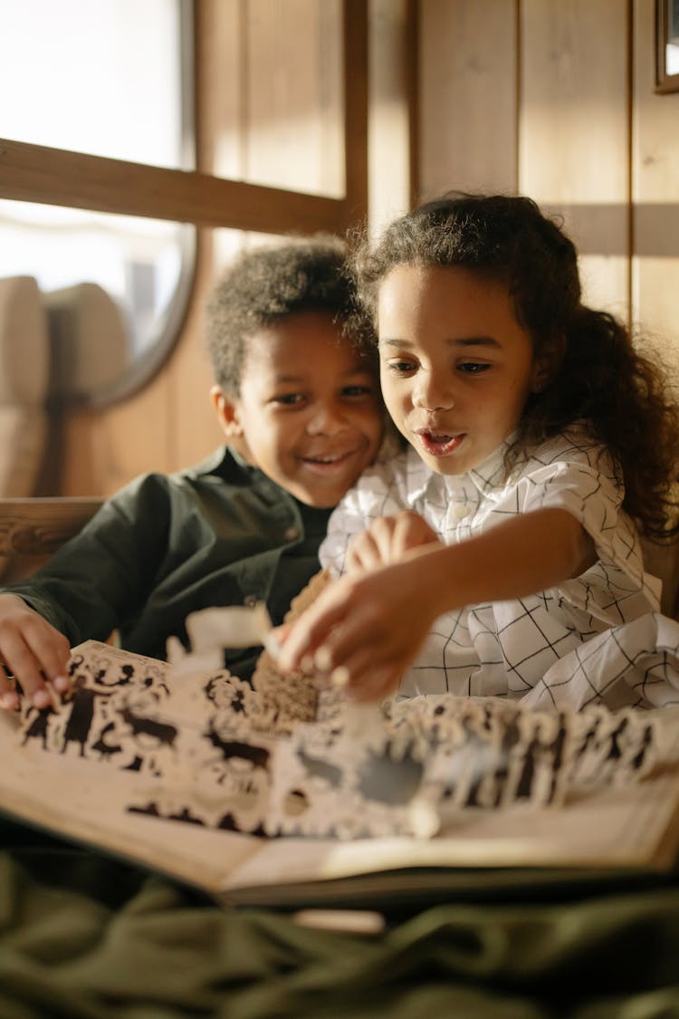 Two Kids Reading A Fairy Tale Book