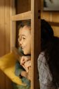 Woman in Yellow Shirt Leaning on Brown Wooden Window