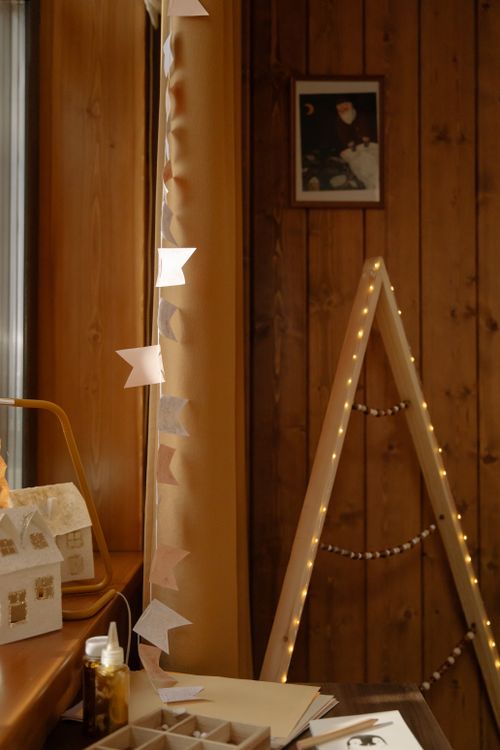 Free A cozy bedroom corner featuring warm lighting and wooden decorations, perfect for inviting ambience. Stock Photo