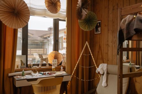 Free Warm wooden room interior featuring creative decor elements and natural light. Stock Photo