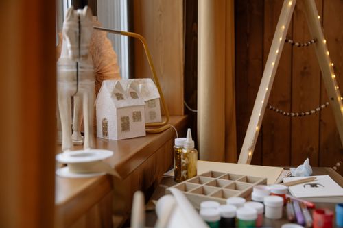 Free A warm and inviting arts and crafts station featuring Christmas decorations and materials on a wooden table. Stock Photo