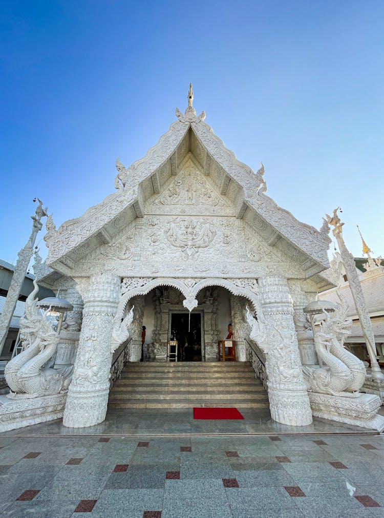 White Buddhist Temple Against Clear Blue Sky