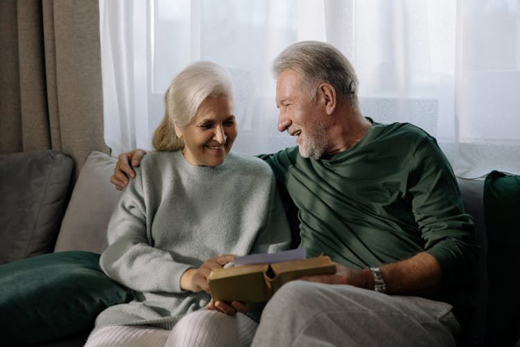 Gray Haired Couple Reading A Book Together 